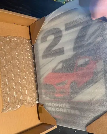 Lifting the foam sheet off the framed poster